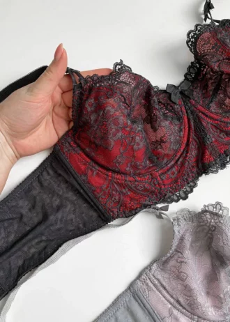 hand-is-holding-tempting-black-and-red-and-grey-lace-bustier-bras-without-foam
