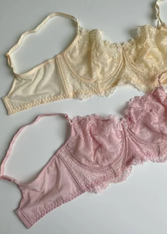 gentle-pink-and-beige-lace-bustier-bras-without-foam-with-bows-on-the-white-background