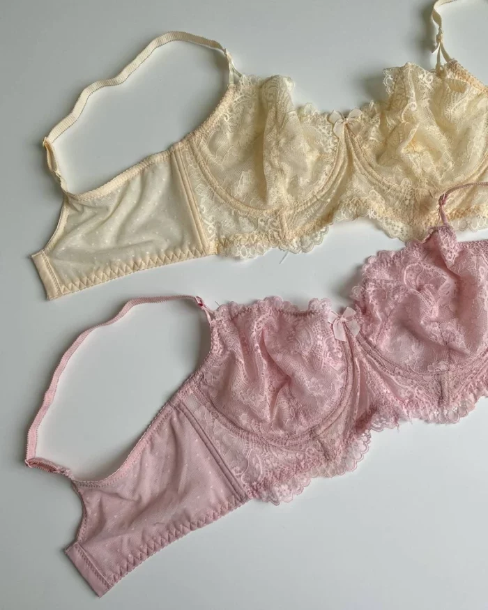 gentle-pink-and-beige-lace-bustier-bras-without-foam-with-bows-on-the-white-background