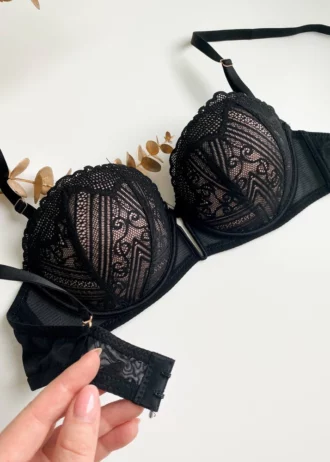 hand-is-holding-a-tempting-black-lace-balconette-bra