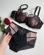 hand-is-holding-beautiful-black-lace-panties-with-roses-on-it