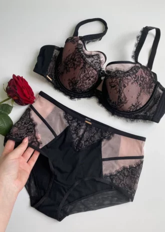 hand-is-holding-beautiful-black-lace-panties-with-roses-on-it
