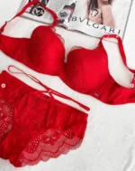 a-red-lace-set-of-a-bra-with-thin-foam-and-panties-with-belts-with-a-magazine-on-the-background