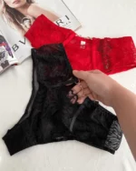 hand-is-holding-beautiful-black-and-red-high-waisted-brazilian-panties-with-flower-patterns-mesh-and-belts