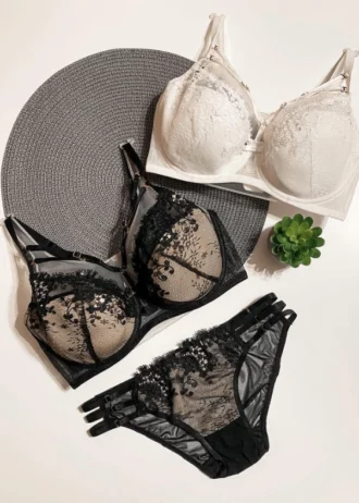 tempting-black-and-beige-and-white-sets-of-bras-and-panties-with-gentle-flower-pattern-mesh-and-belts-with-a-plant-nearby