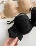 hand-is-holding-black-and-beige-lace-bras-with-thin-foam-for-C-D-cups