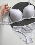 hand-is-holding-white-lace-set-of-bra-and-panties-bundled