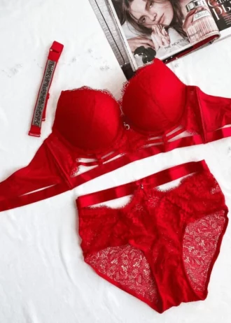 red-lace-set-of-a-bustier-bra-with-push-up-and-high-wasted-panties-with-belts-and-choker-bundled-with-pearls-and a-magazine-on-the-background