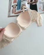 the-backside-of-a-beige-lace-balconette-bra-with-a-bow-for-C-cup-with-a-magazine