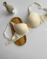 smooth-beige-classic-bra-with-decorative-straps-for-C-cup-with-a-small-jug-nearby