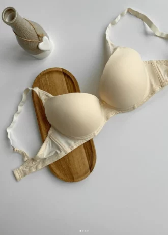 smooth-beige-classic-bra-with-decorative-straps-for-C-cup-with-a-small-jug-nearby