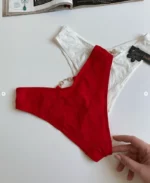 hand-is-holding-smooth-white-and-red-high-waisted-tanga-panties-with-a-golden-belt