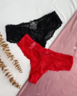 black-and-red-lace-brazilian-panties-with-incisions-and-bows-having-an-artificial-branch-on-the-background