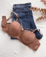 beautiful-dark-beige-lace-balconette-bra-without-push-up-and-with-a-bow-and-belts-on-the-jeans-with-an-artifical-branch-nearby