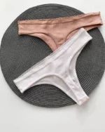 the backside of cute white and beige cotton thongs in a ribbed design